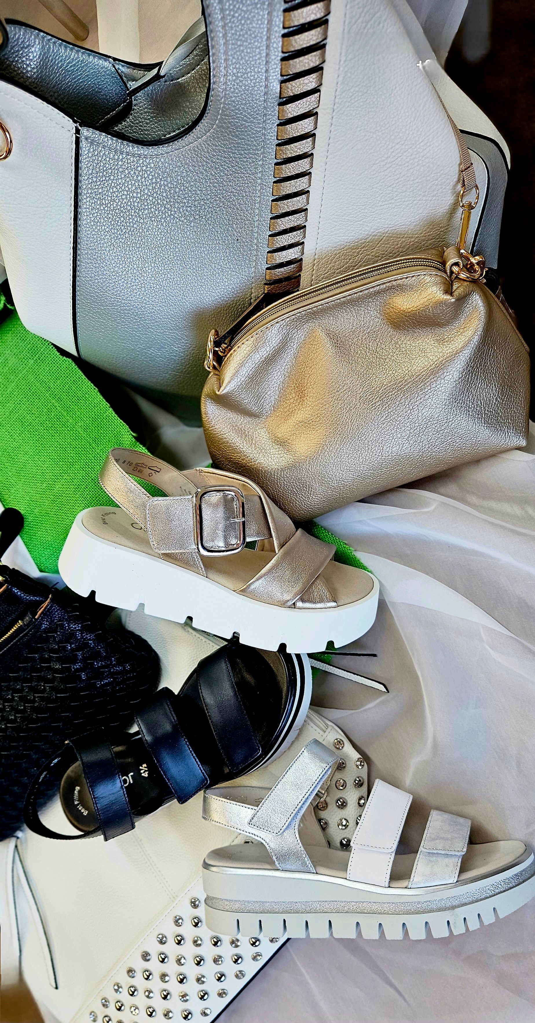 A pair of sneakers are floating in the air on a white background.