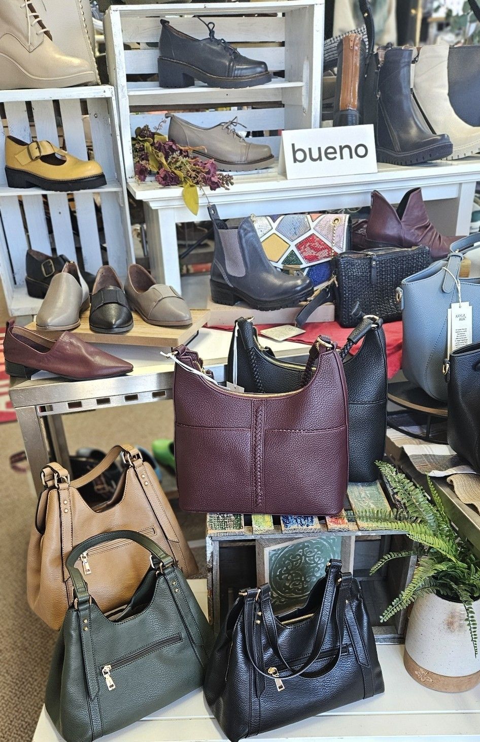 A display of handbags and shoes in a store.