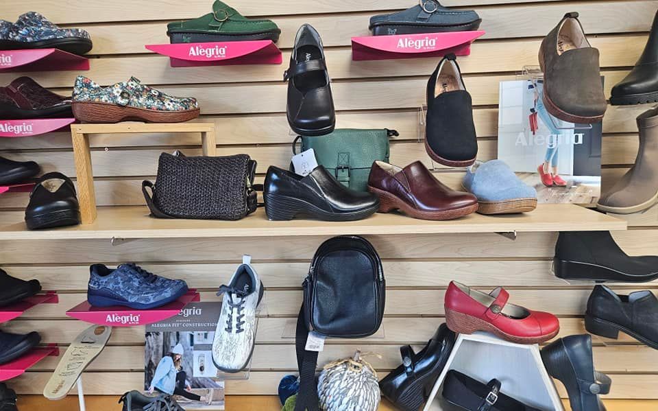 A display of shoes and bags in a shoe store