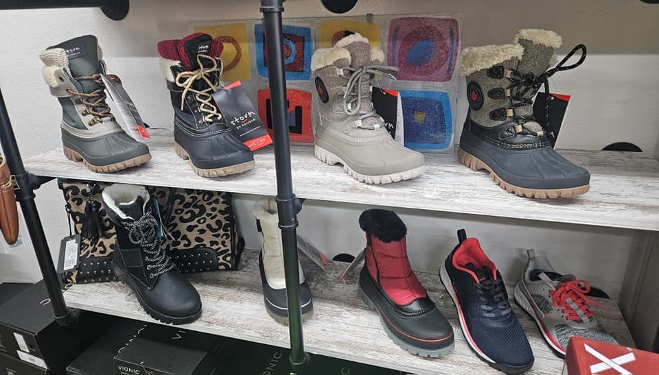 A shelf filled with a variety of shoes and boots