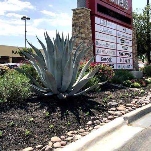 Outlet Signage Landscape — San Marcos, TX — Diamondback Landscaping & Lawn Care, Inc.