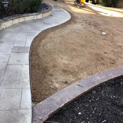 Soil Near Concrete Walkway — San Marcos, TX — Diamondback Landscaping & Lawn Care, Inc.