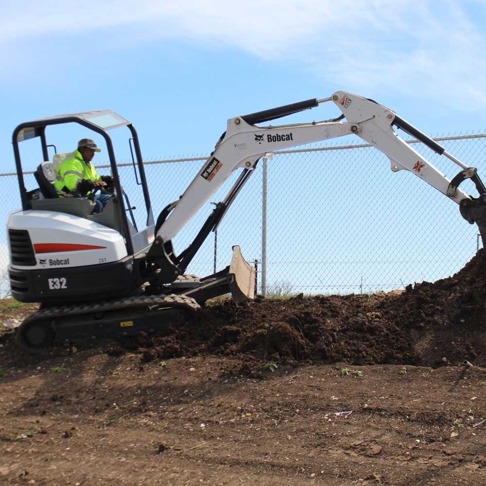 Man Using a Backhoe — San Marcos, TX — Diamondback Landscaping & Lawn Care, Inc.