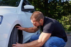 Man changing tire | Ken's Tire & Auto