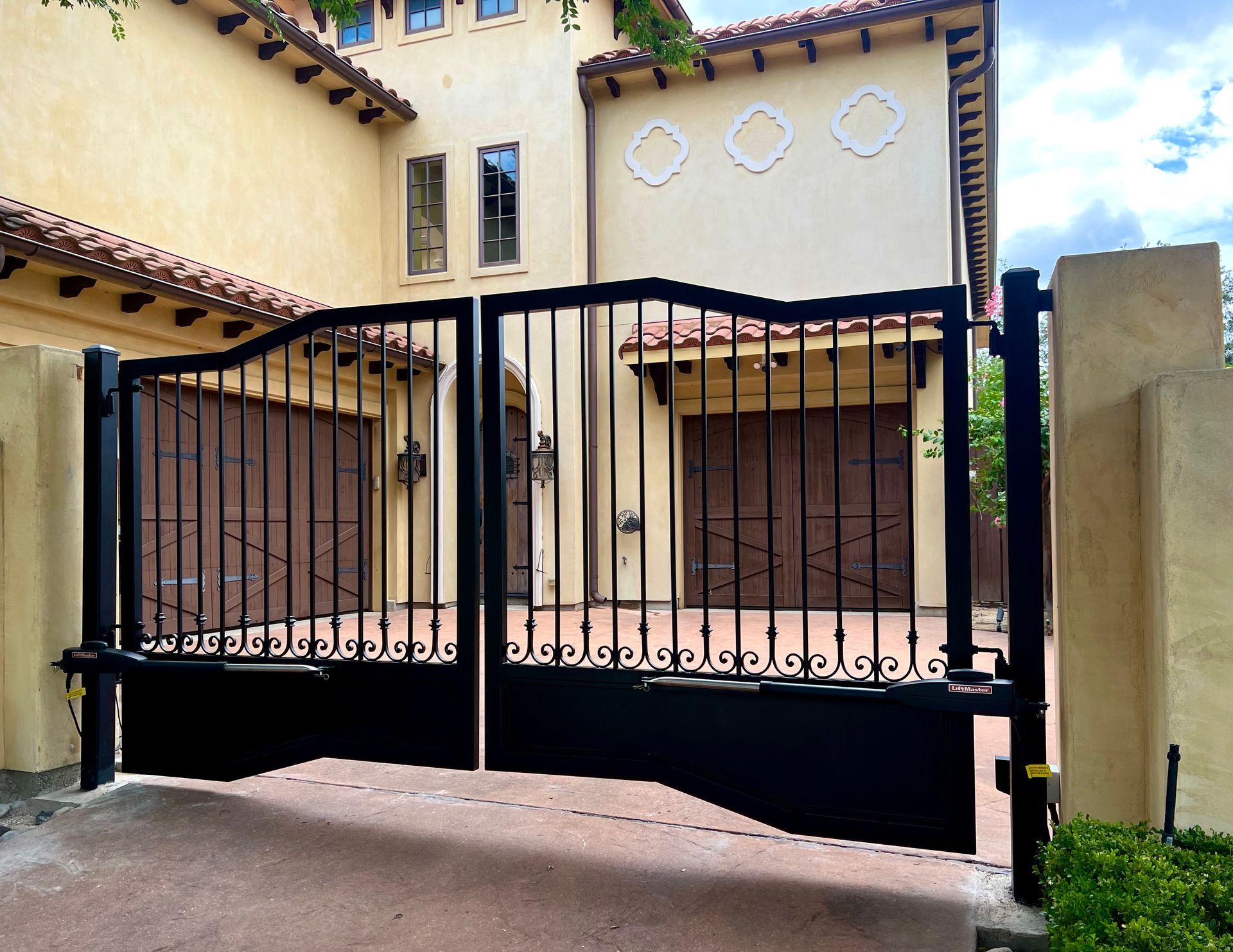 A large house with a black gate in front of it
