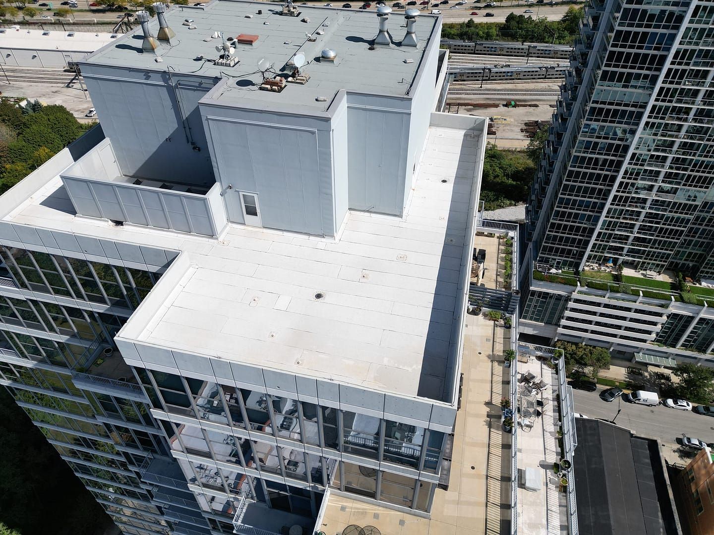 High-angle view of modern high-rise buildings with glass windows and flat roofs.