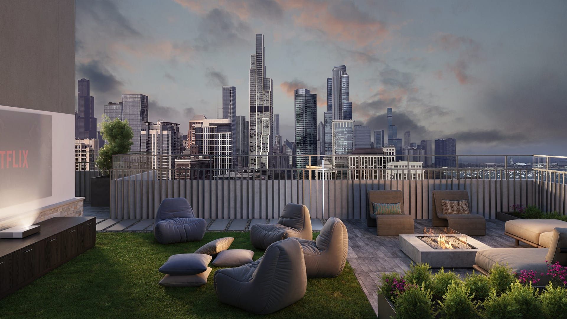 Rooftop lounge with city skyline view: beanbag chairs, fire pit, TV, and cityscape at dusk.