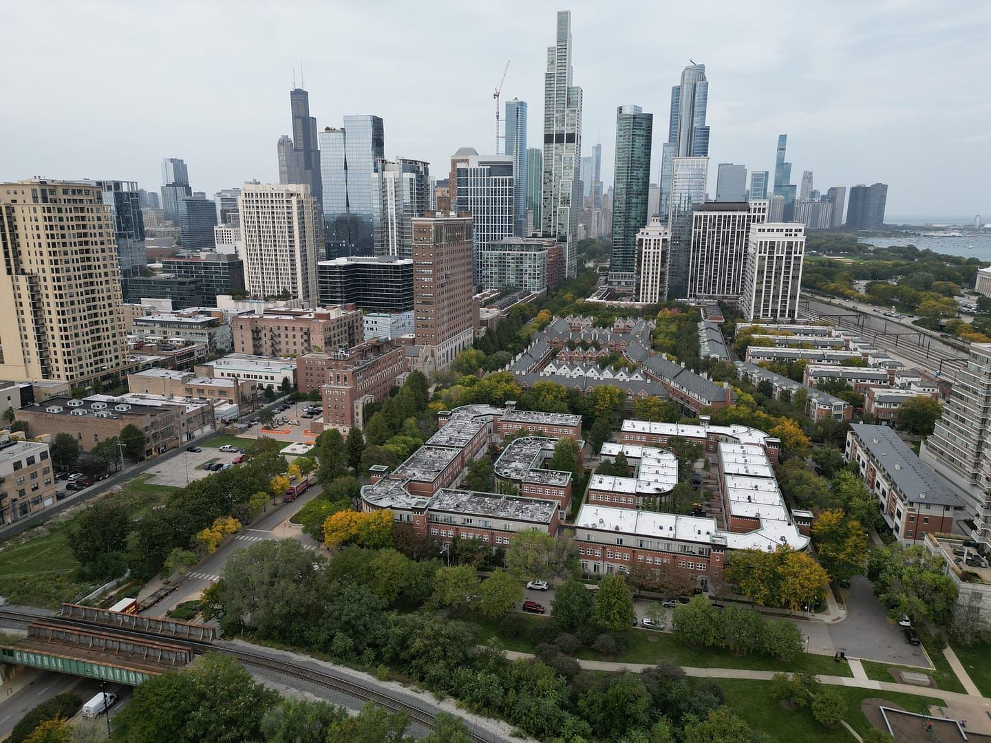 Aerial view of Chicago skyline with buildings and residential areas, overcast sky.