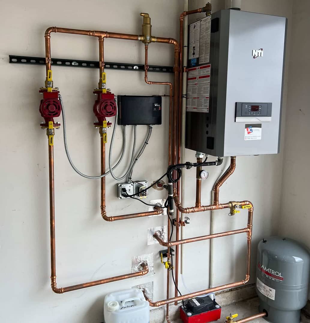 Copper piping and a wall-mounted water heater and pump system in a garage setting.