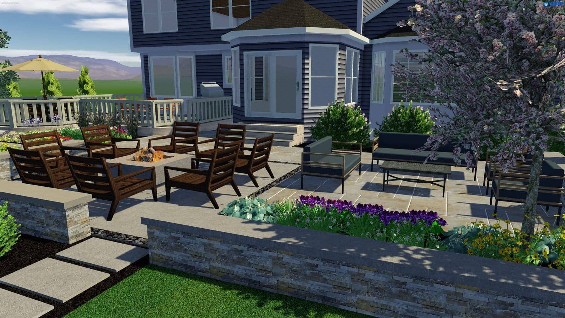 Patio with seating areas, stone walls, and a house in the background. Greenery and flowers add color to the scene.