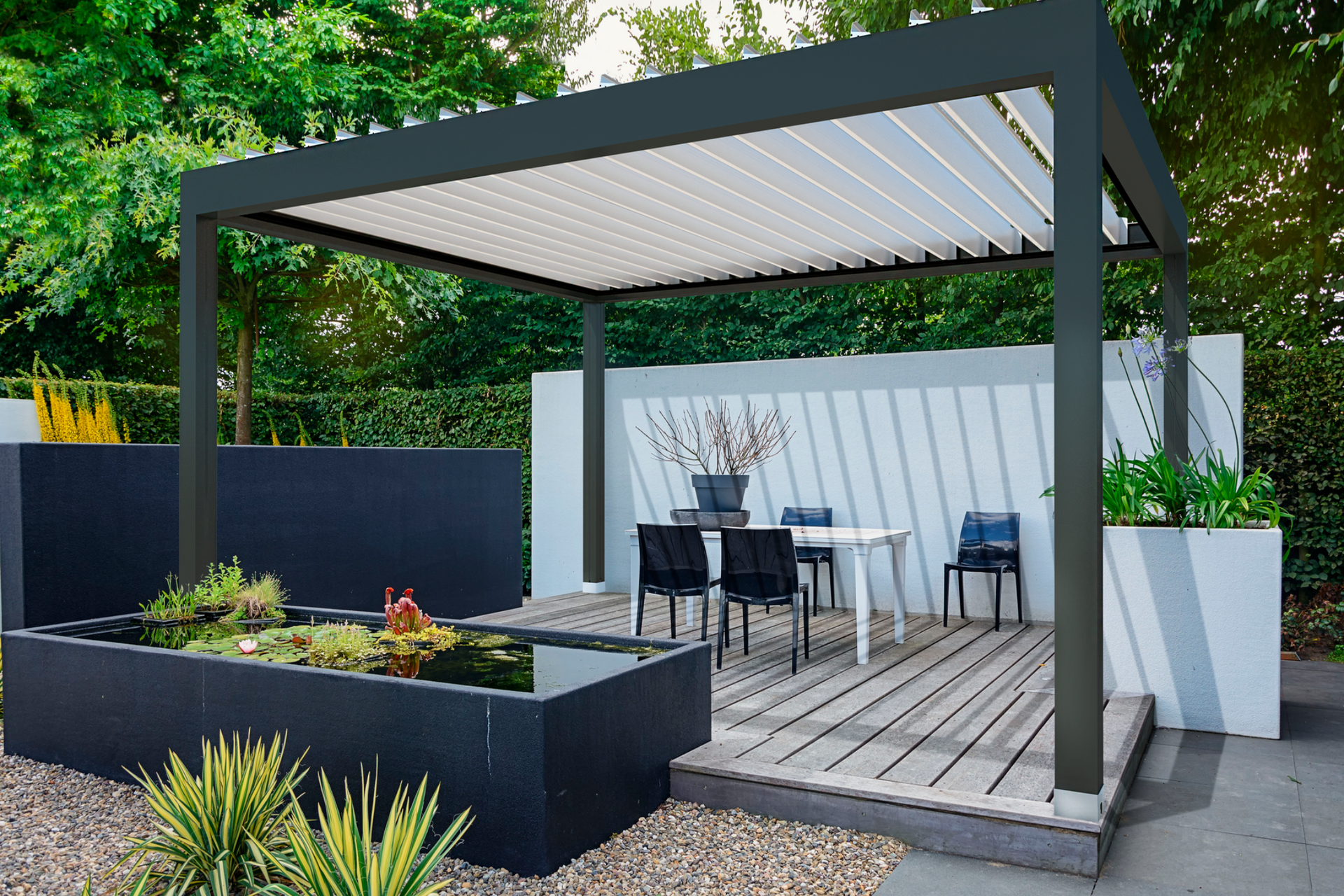 Modern outdoor patio with a pergola, table, chairs, and a small pond.