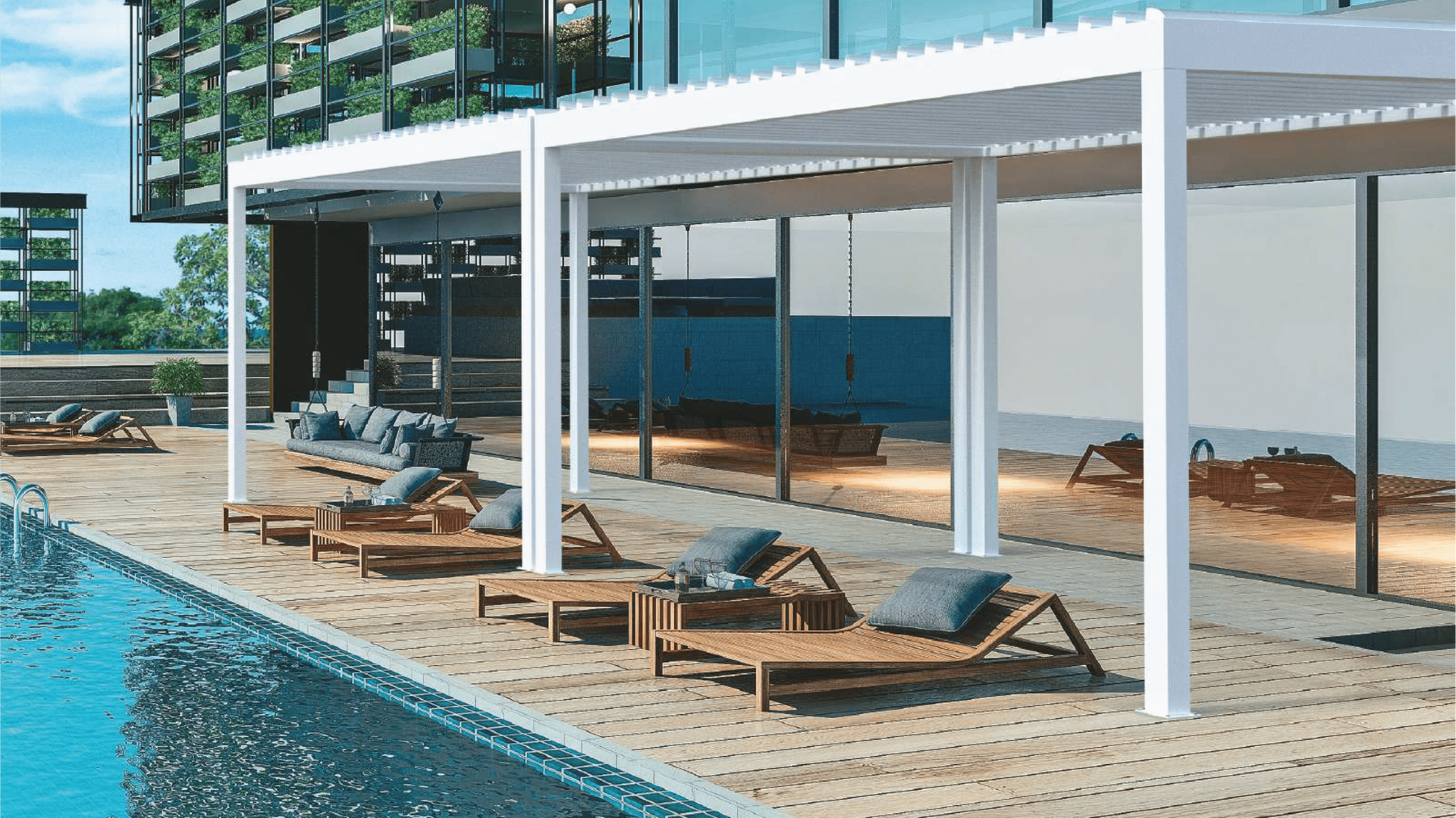 Poolside lounge area with white pergolas, wooden chaise lounges, and a building in the background.