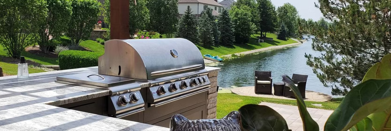 Outdoor grill with a view of a lake.