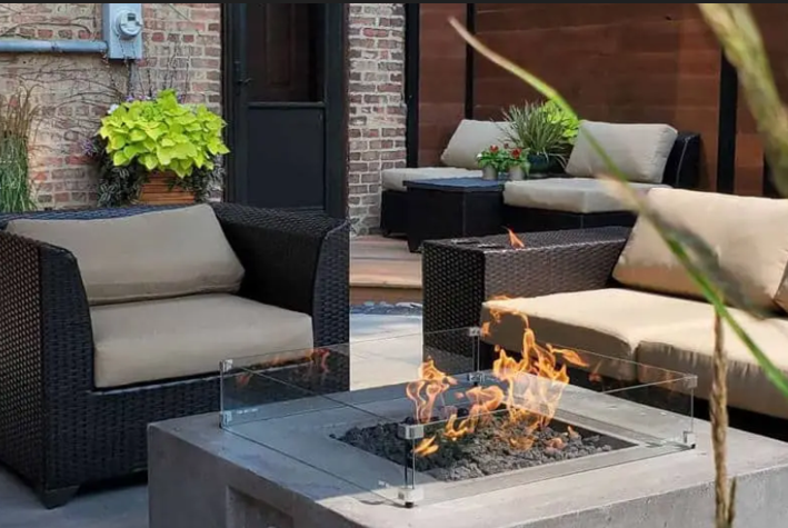 Outdoor patio with wicker furniture, fire pit, and brick wall.