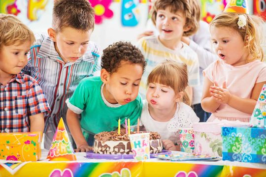 Children blowing birthday candles
