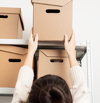 Woman Getting the Cardboard Box — Herndon, VA — Eureka Van & Storage Co., Inc.