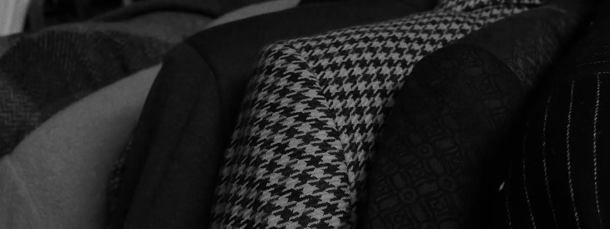 a black and white photo of a jacket with a houndstooth pattern