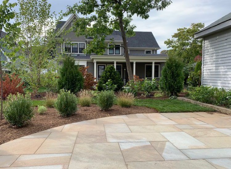 A large house with a patio in front of it