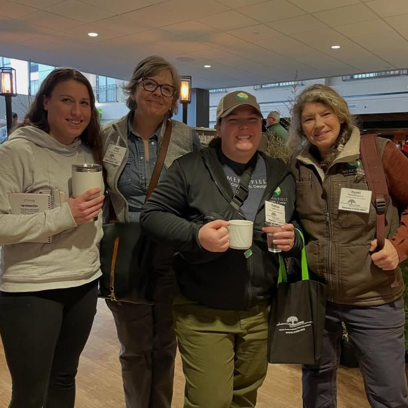 A group of people posing for a picture with one woman wearing glasses