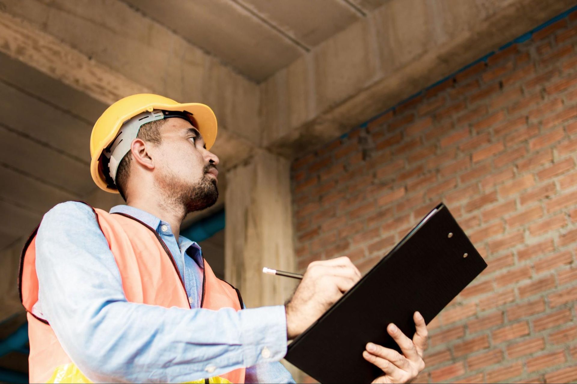 Home inspector at work, holding clipboard