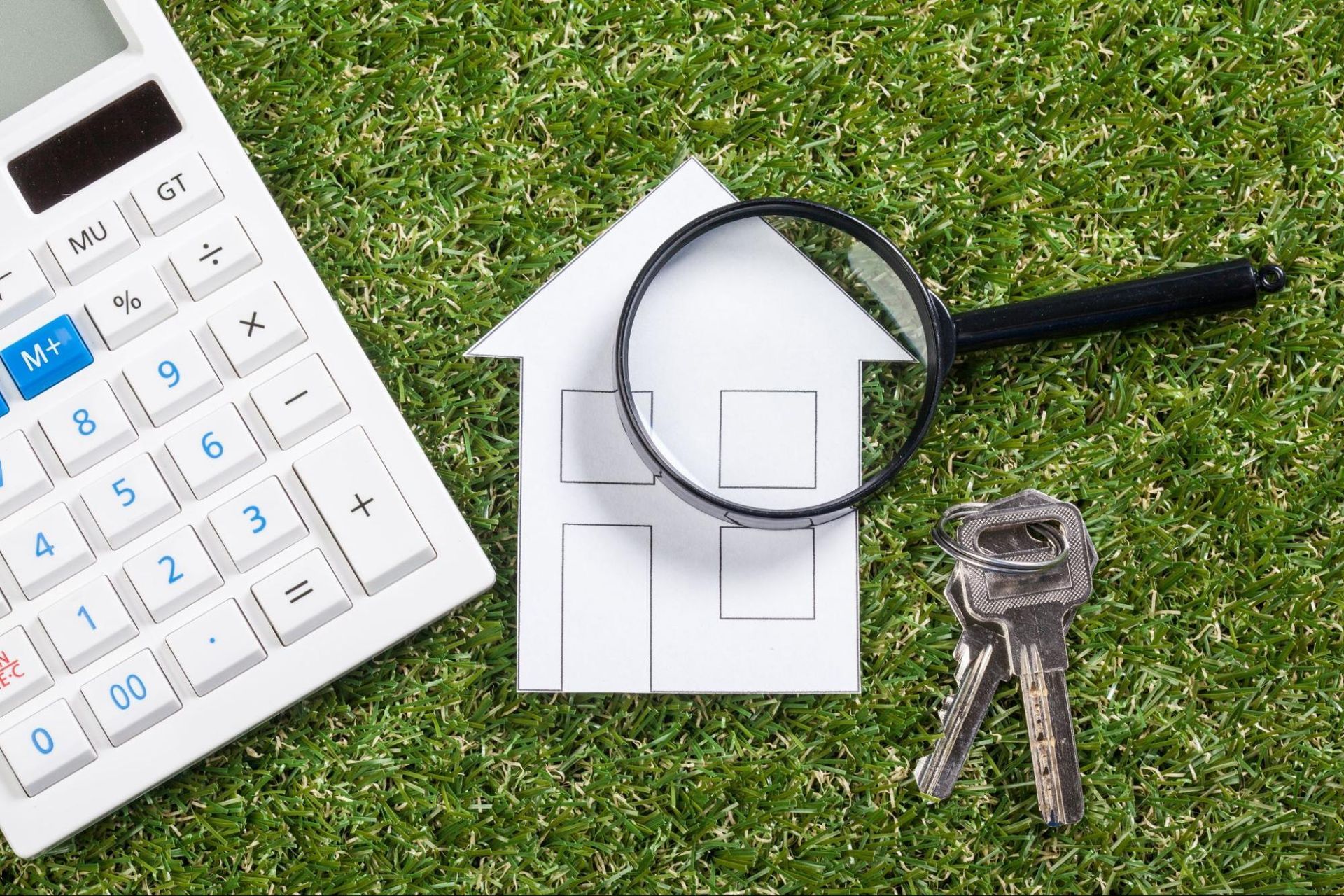 paper house, magnifying glass, keys, and a calculator, representing home inspection in Willis
