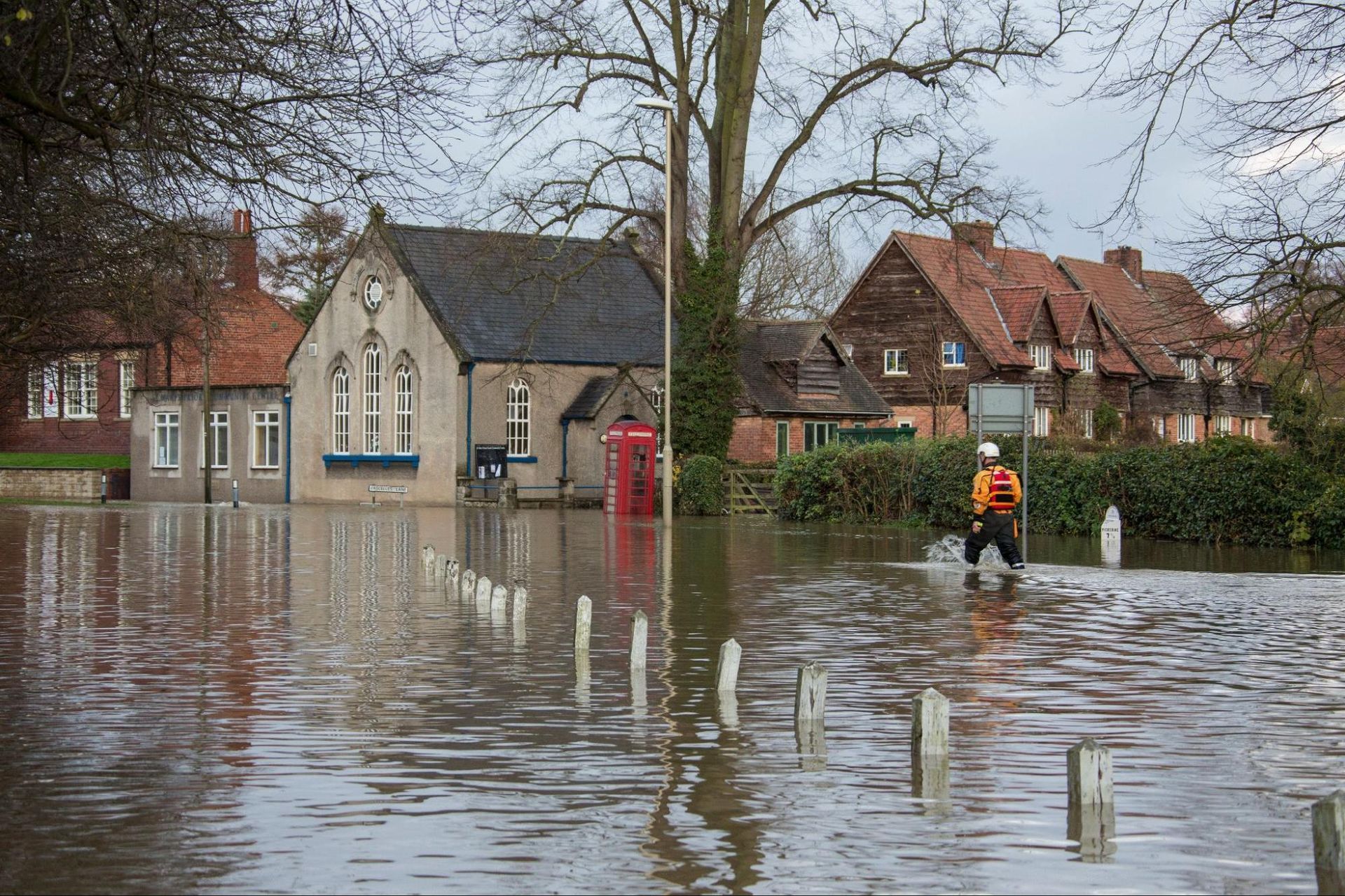 Flooded residential area with homes likely needing a home inspection for water damage.