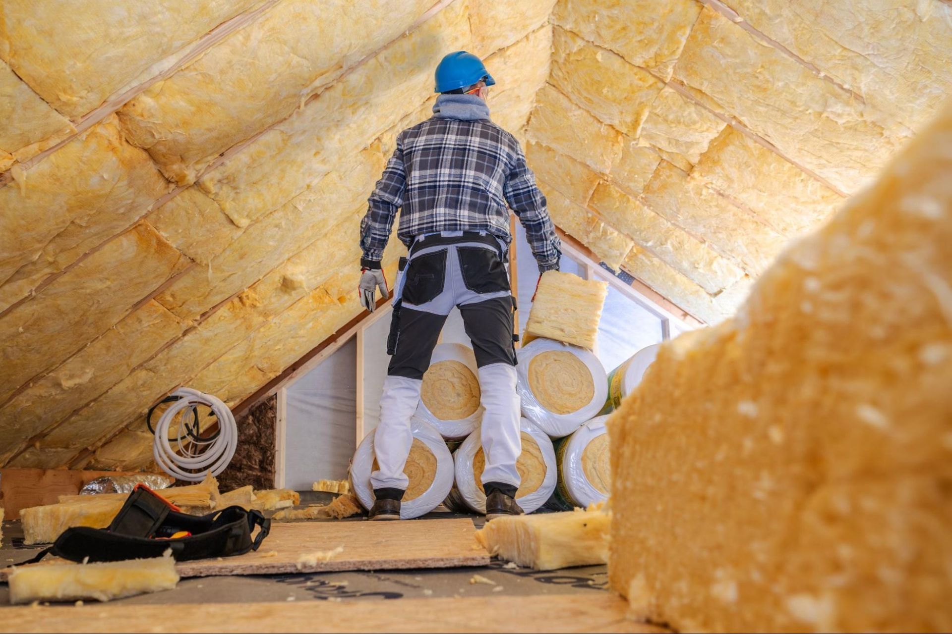 worker insulates attic
