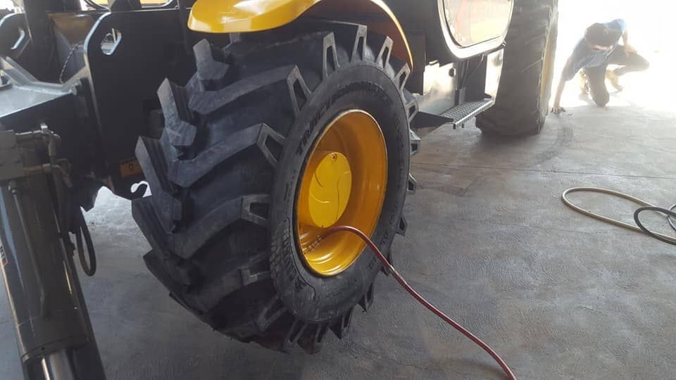 Mechanic Working on Tyre — Auto Repair Services in Picton, NSW