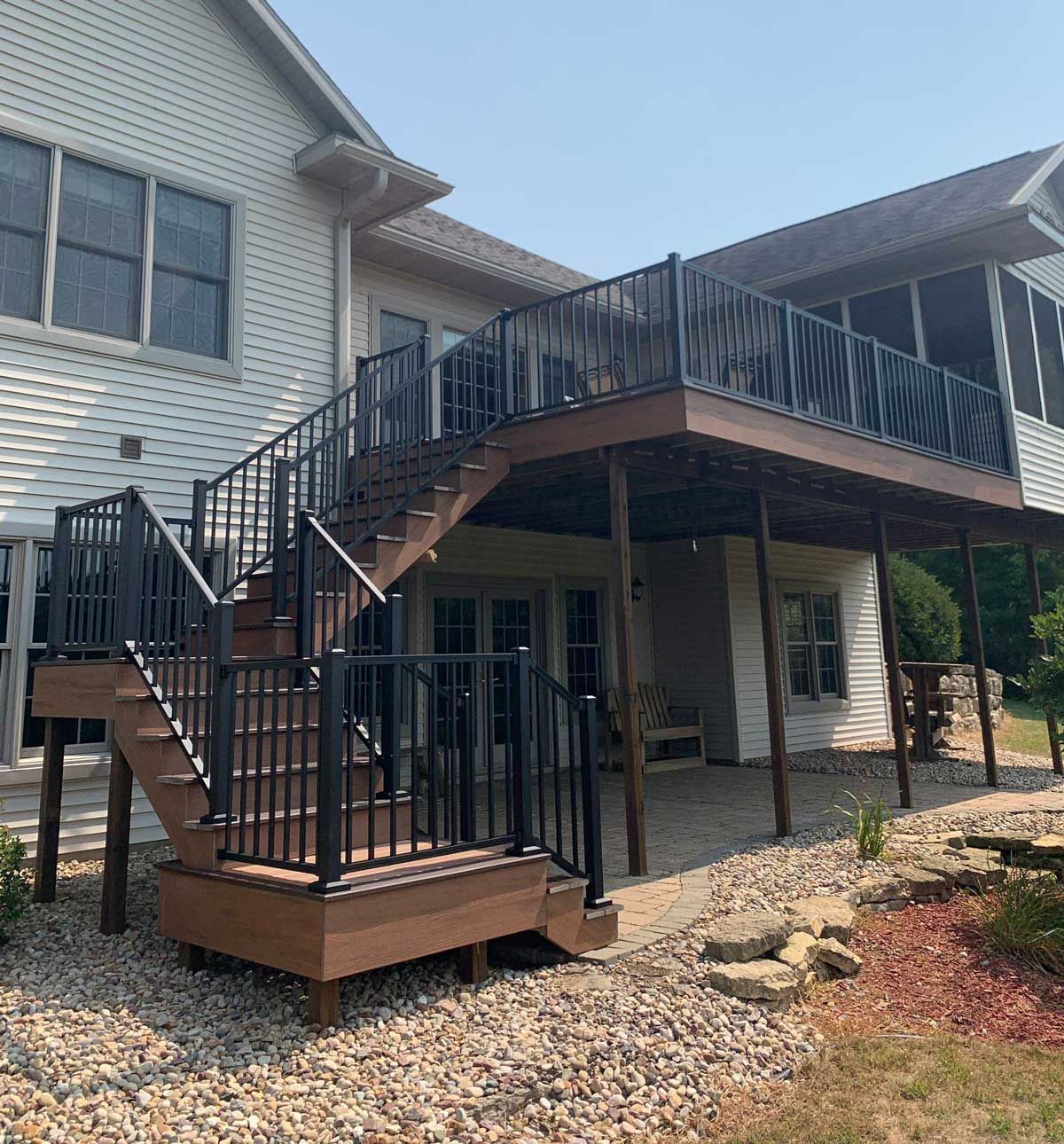 A house with a large deck and stairs leading up to it
