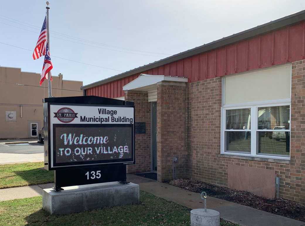 Village municipal building with a sign that reads 