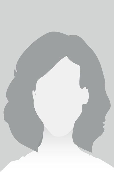 Silhouette of a person, mid-chest up, with short, wavy hair. Gray background.