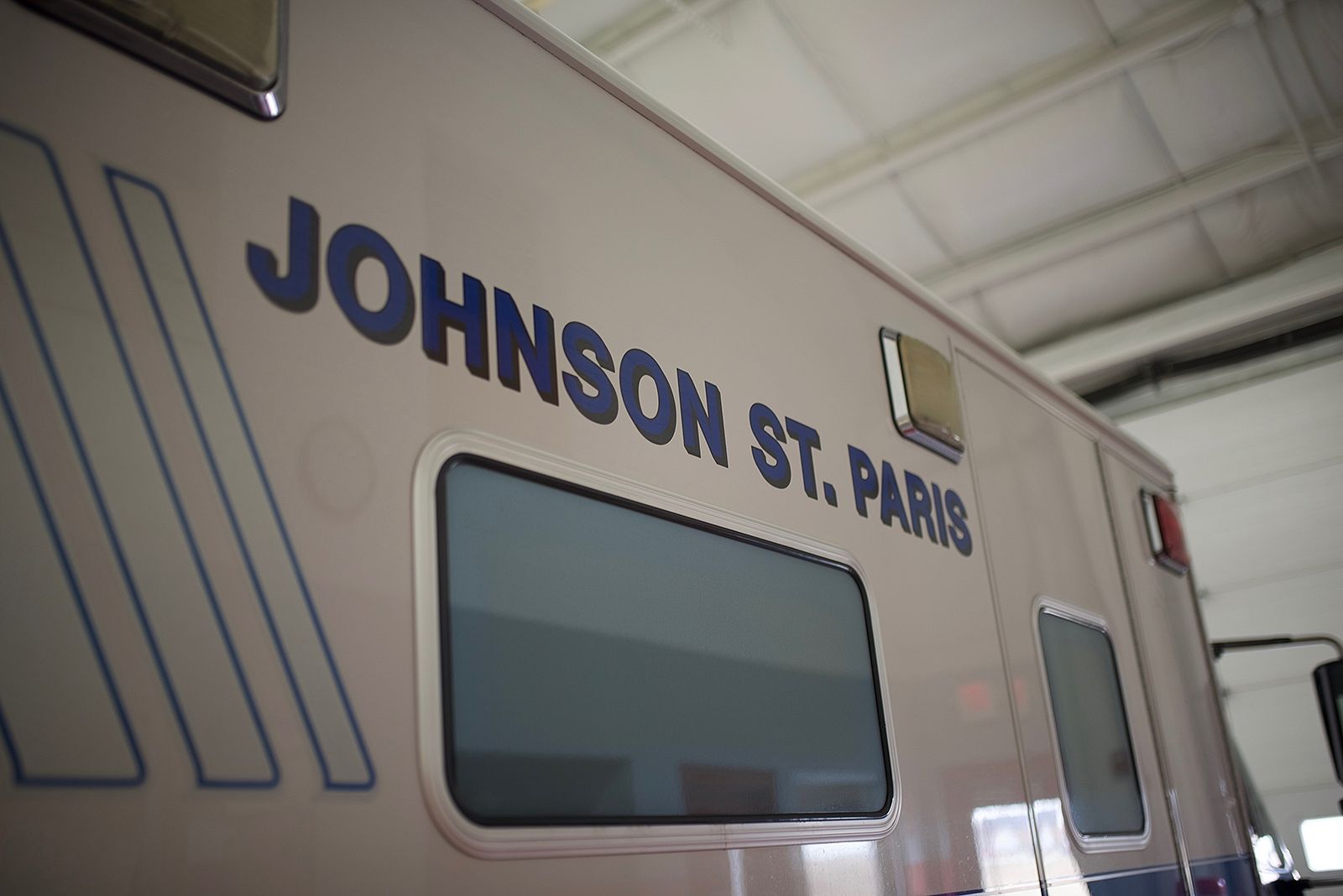 Side of ambulance, blue text reading 