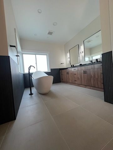 There is a bathtub in the middle of the bathroom