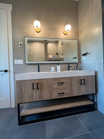 A bathroom with a double sink and a large mirror