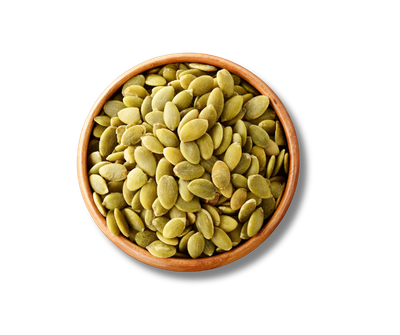 A wooden bowl filled with pumpkin seeds on a white background.