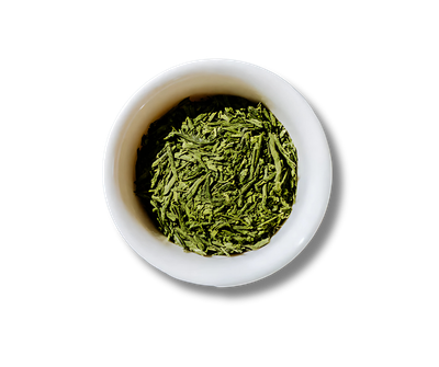 A white bowl filled with green tea leaves on a white background