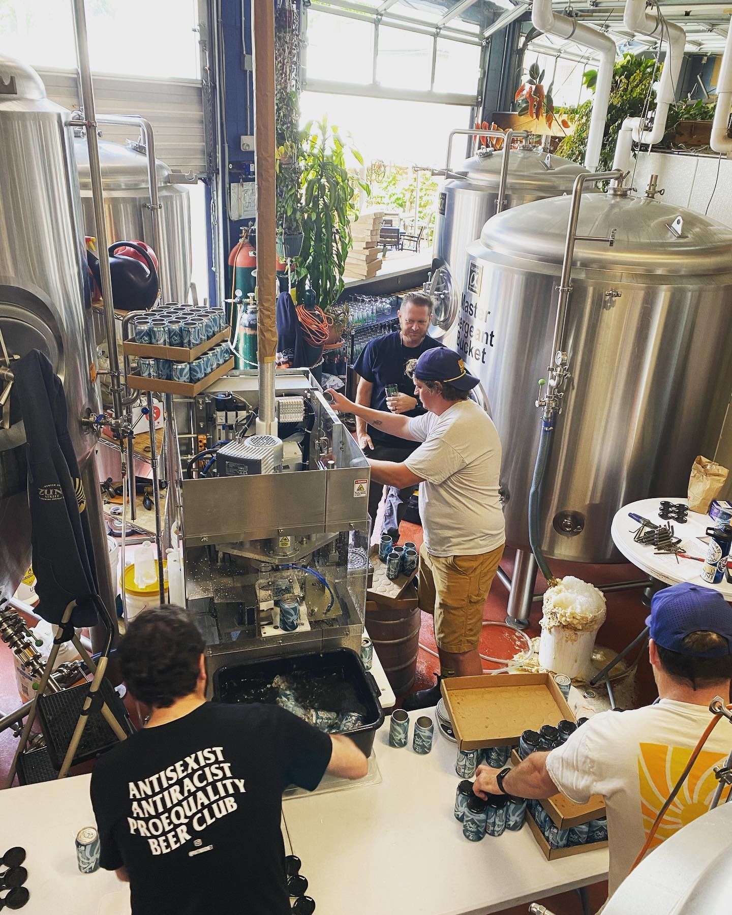 A group of men are working in a brewery.