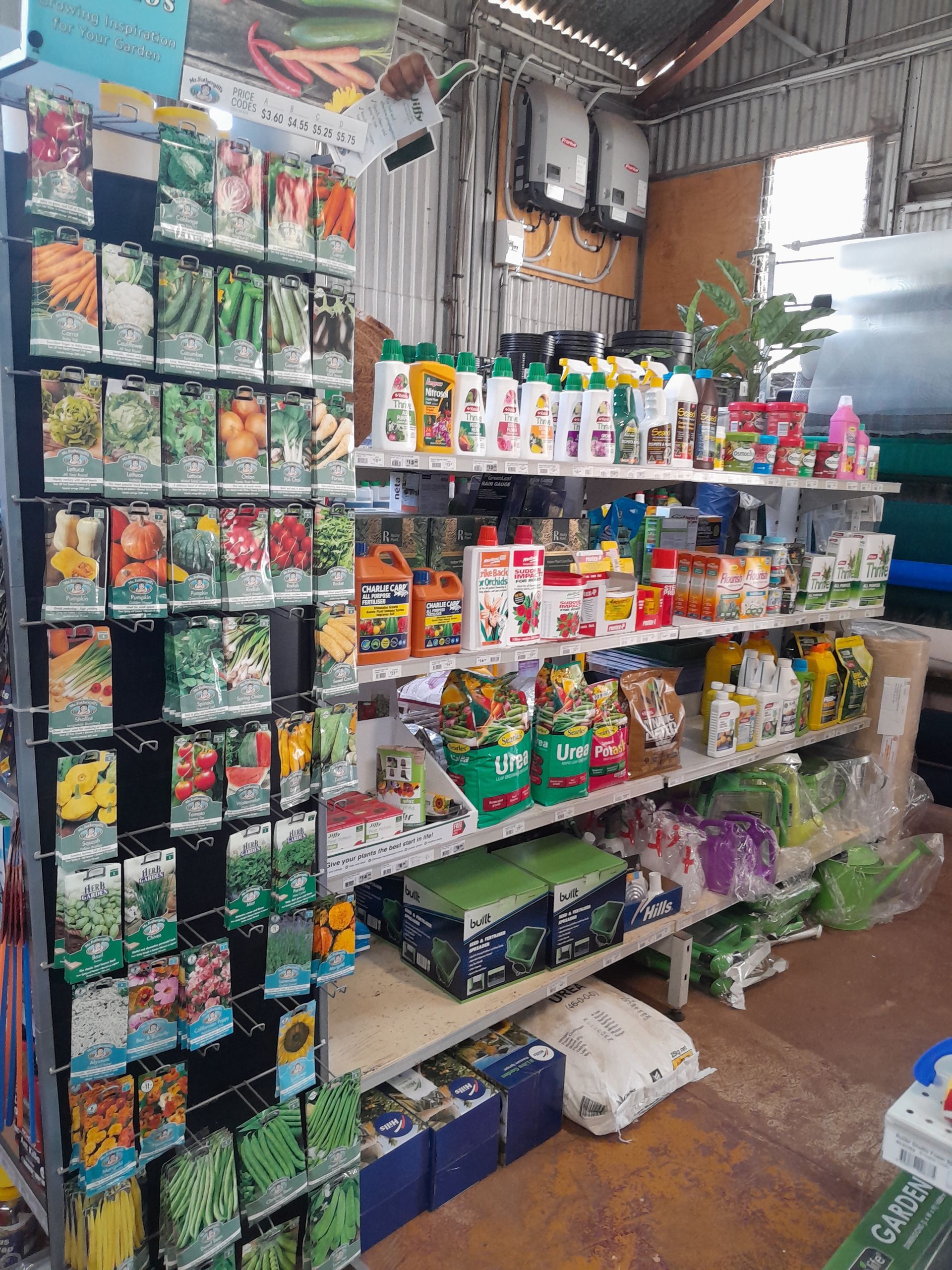A Bunch Of Shovels Are Sitting On A Shelf In A Store — Proston Rural Supplies In Proston, QLD