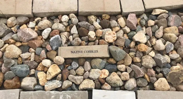 A pile of rocks and bricks with a sign that says native cobblestone.
