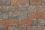 A close up of a brick wall made of different colored bricks.