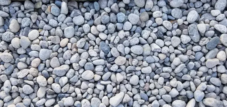 A pile of rocks sitting on top of each other on the ground.