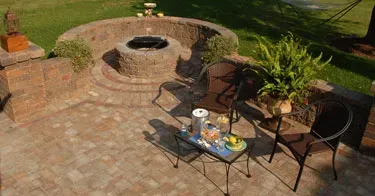 There is a fire pit in the middle of the patio.