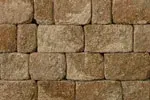 A close up of a wall made of brown bricks.