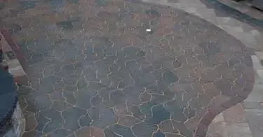 A close up of a brick floor with a pattern on it.