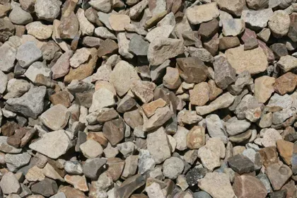 A pile of rocks is sitting on the ground.