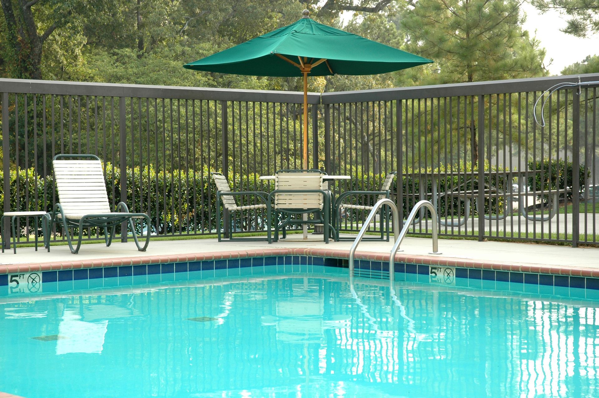 Peaceful Poolside Scene, with Umbrella, Table, and Chairs | Sydney, Nsw | Mick's Pool Safety