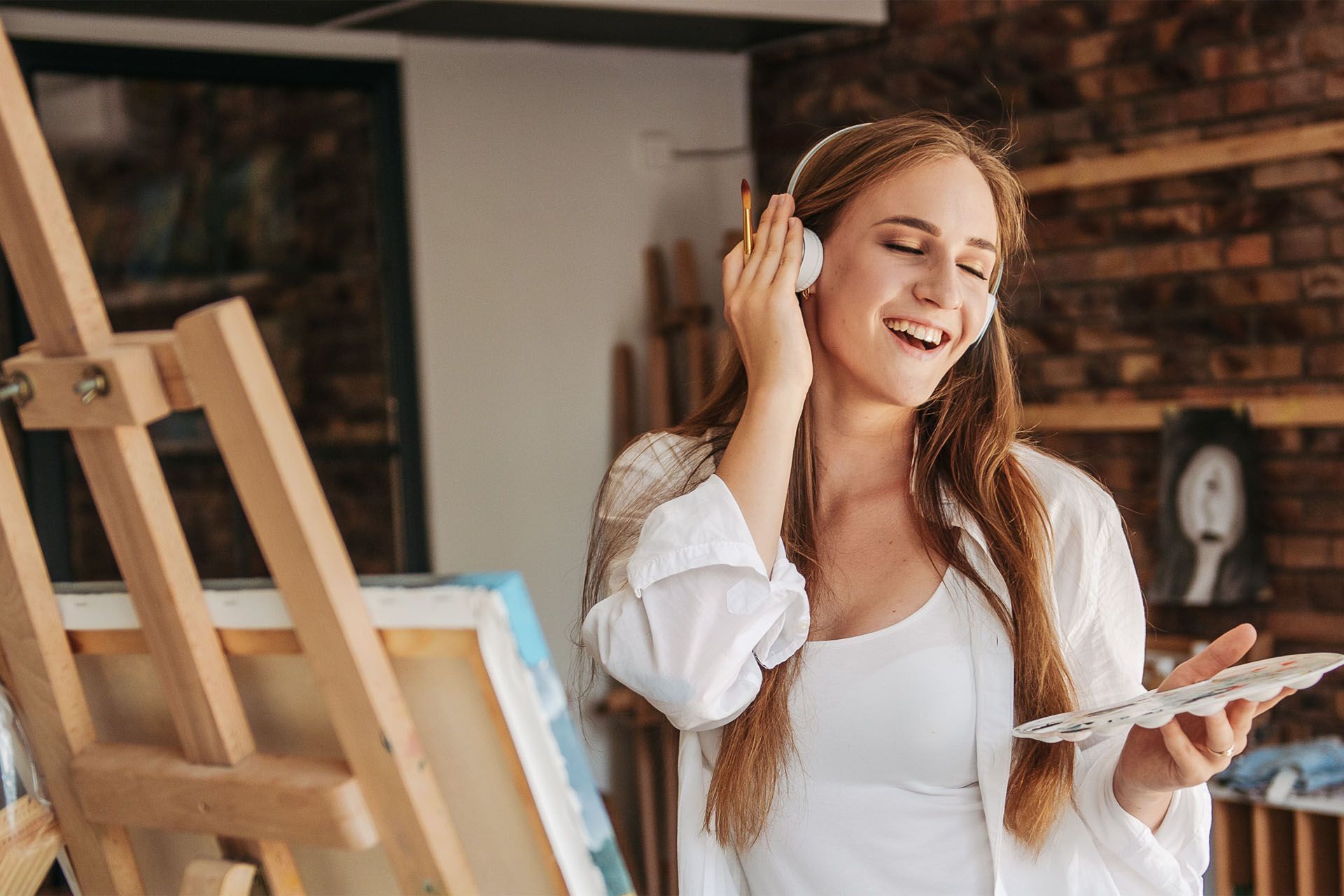 lady listening to music and painting picture