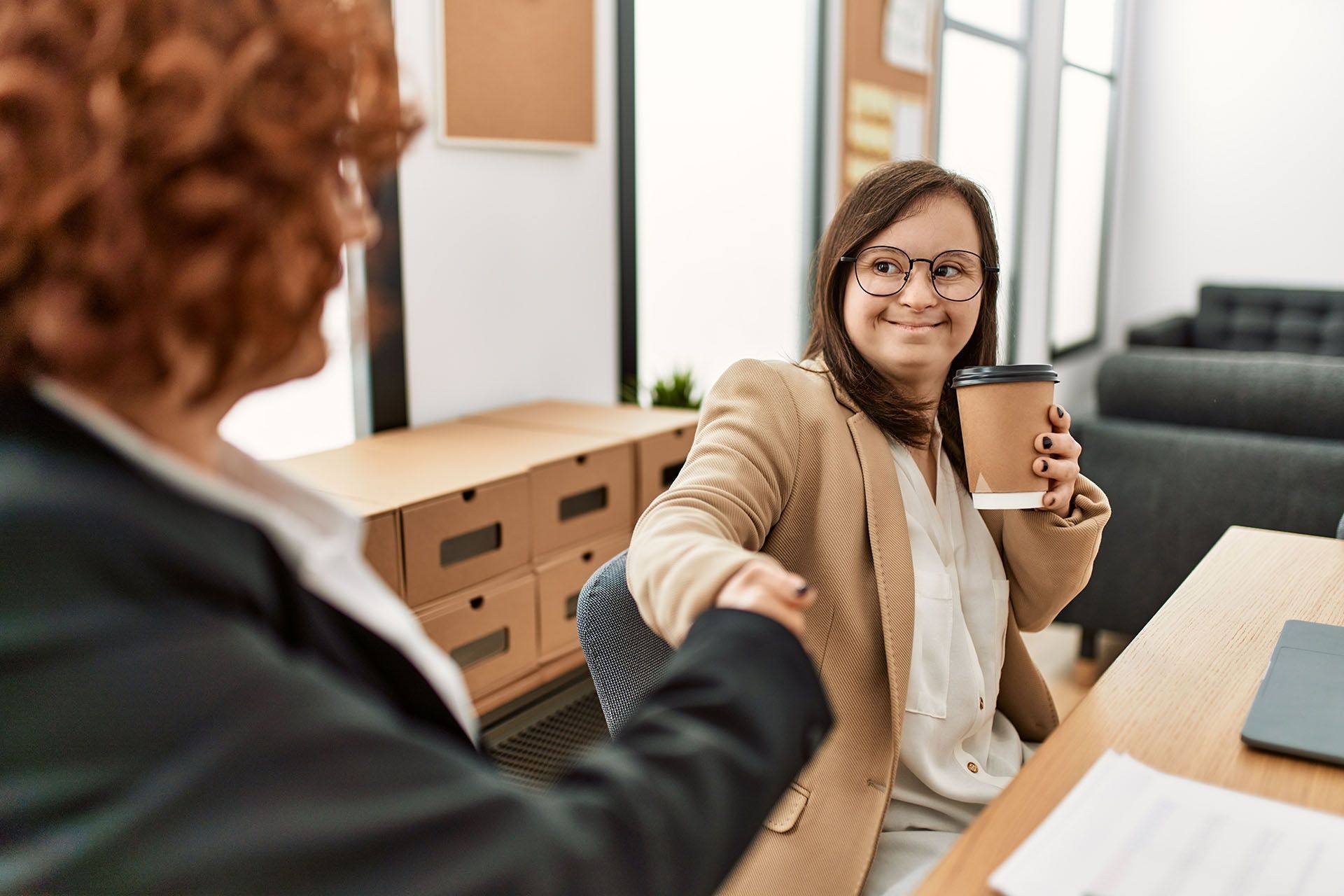 two woman shaking hands