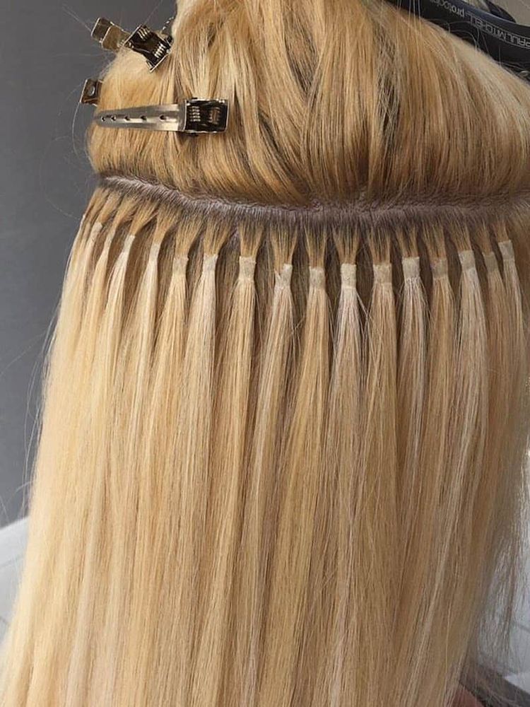 Eine Nahaufnahme der Haare einer Frau mit Extensions darin.