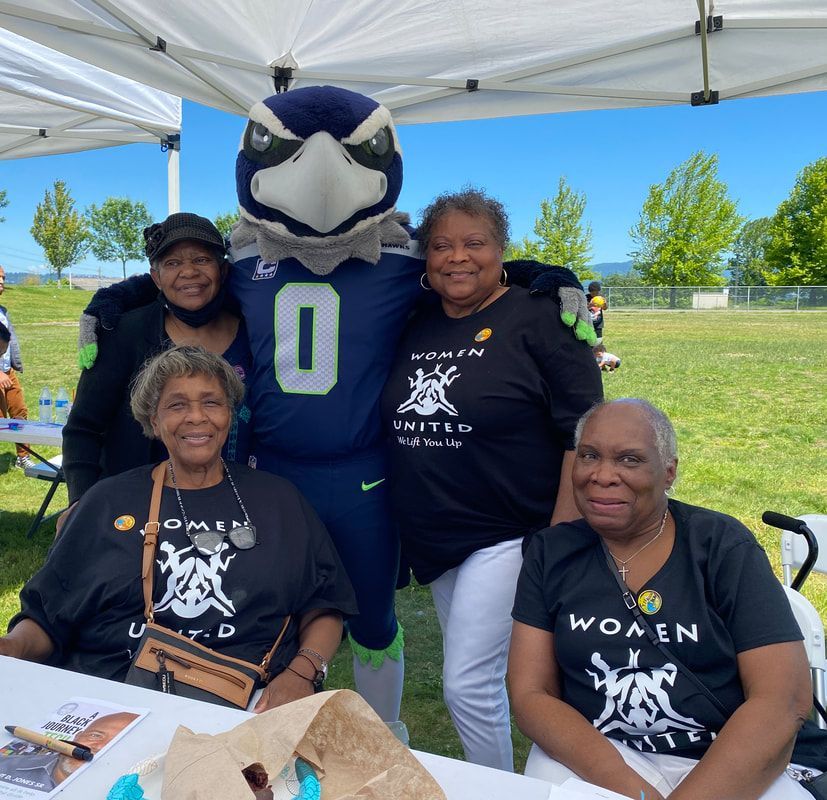 A group of women are posing for a picture with a mascot wearing a number 0 jersey